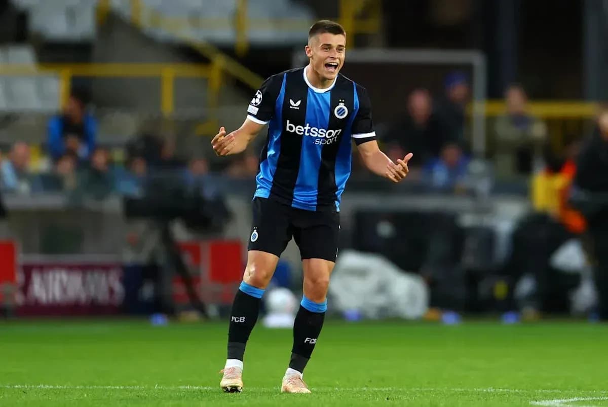 Player gesturing during a match in blue and black kit Player gesturing during a match in blue and black kit