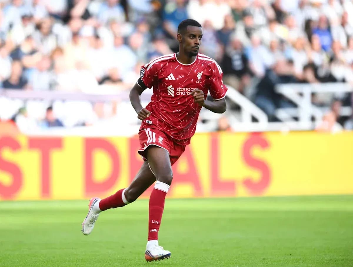Player in red kit running on the pitch Player in red kit running on the pitch