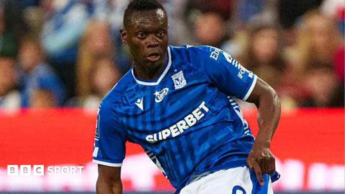 Player in blue jersey dribbling the ball on field Player in blue jersey dribbling the ball on field