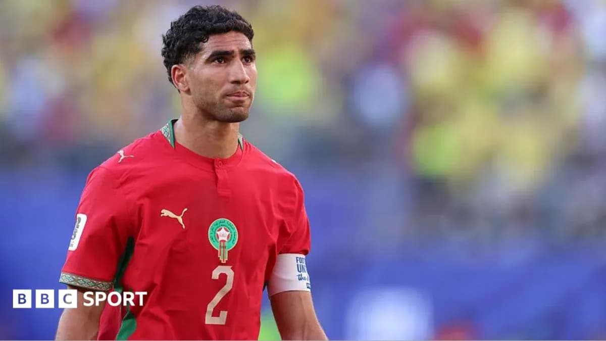 Player in red Morocco jersey on the field Player in red Morocco jersey on the field