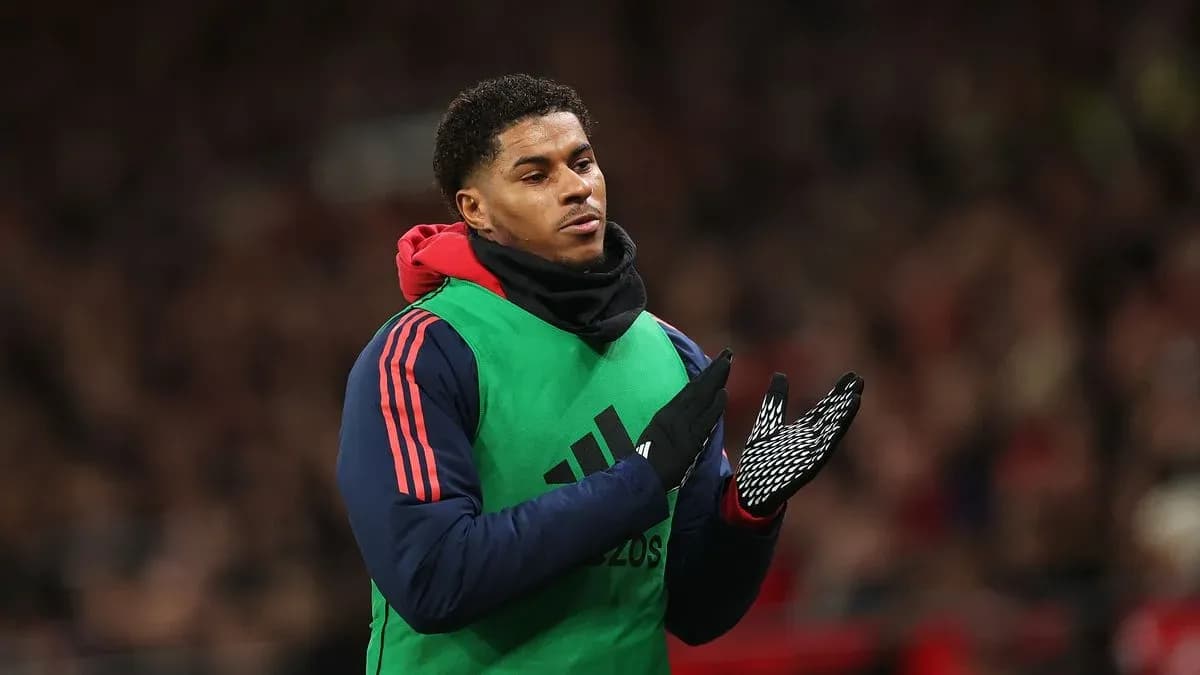 Player in warm-up gear clapping on the sideline Player in warm-up gear clapping on the sideline