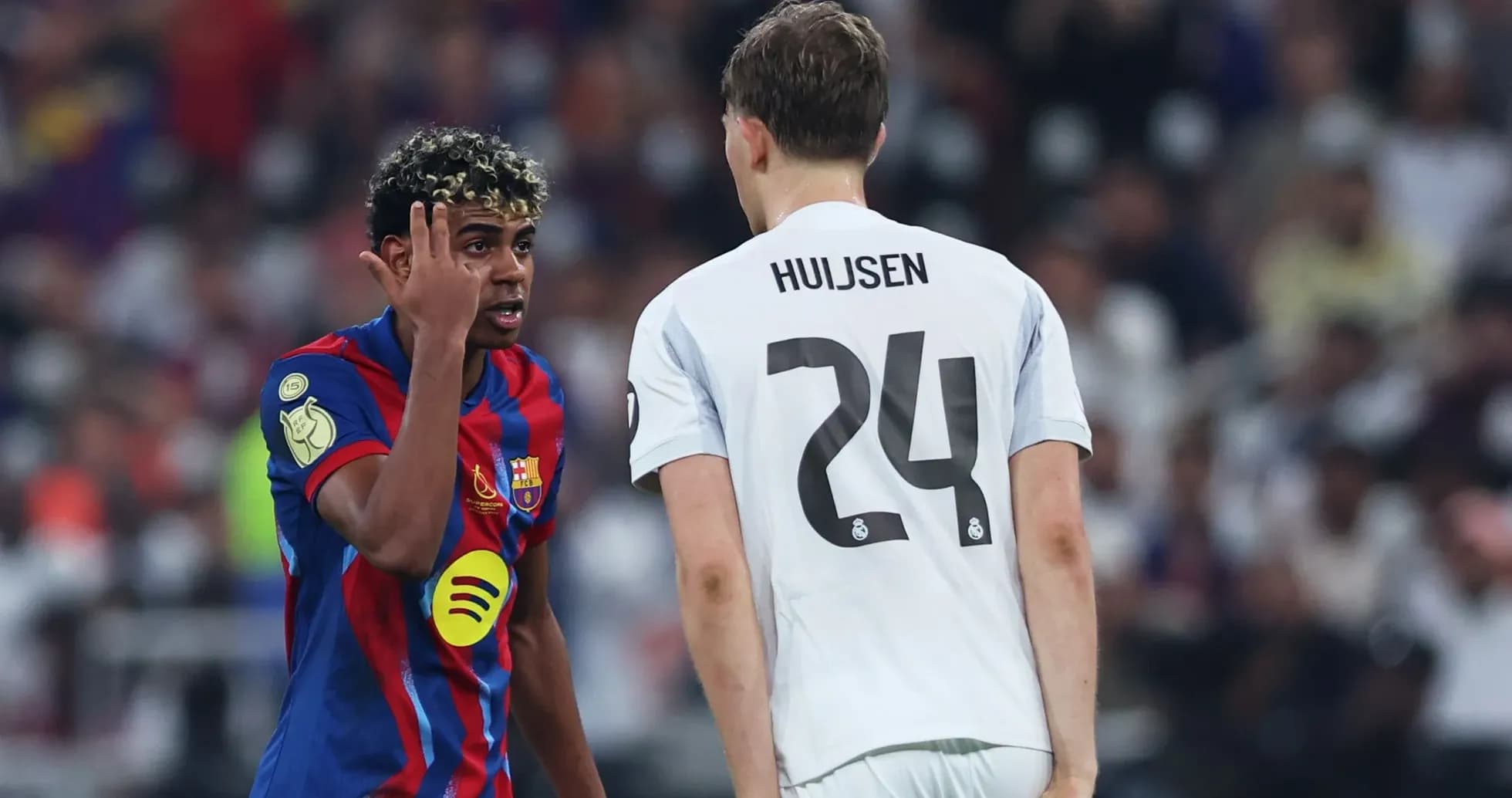Barcelona player interacting with Real Madrid opponent Barcelona player interacting with Real Madrid opponent
