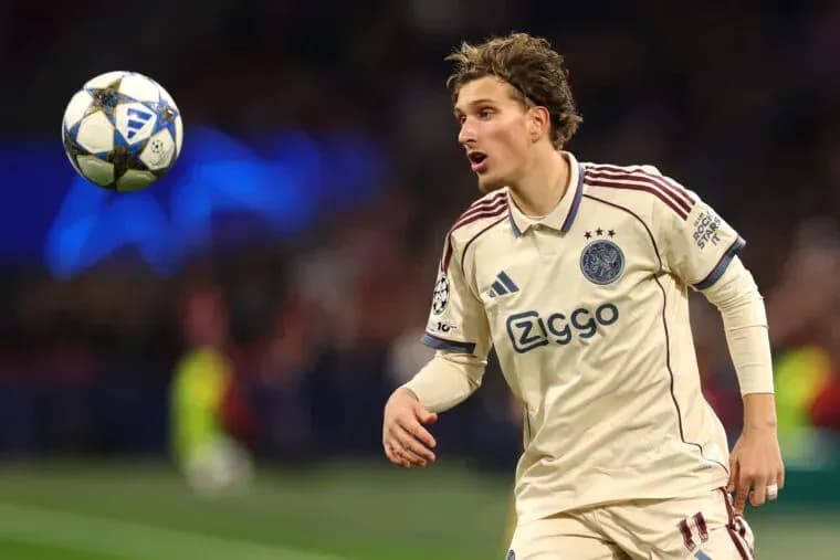 Player in Ajax kit controlling a soccer ball Player in Ajax kit controlling a soccer ball