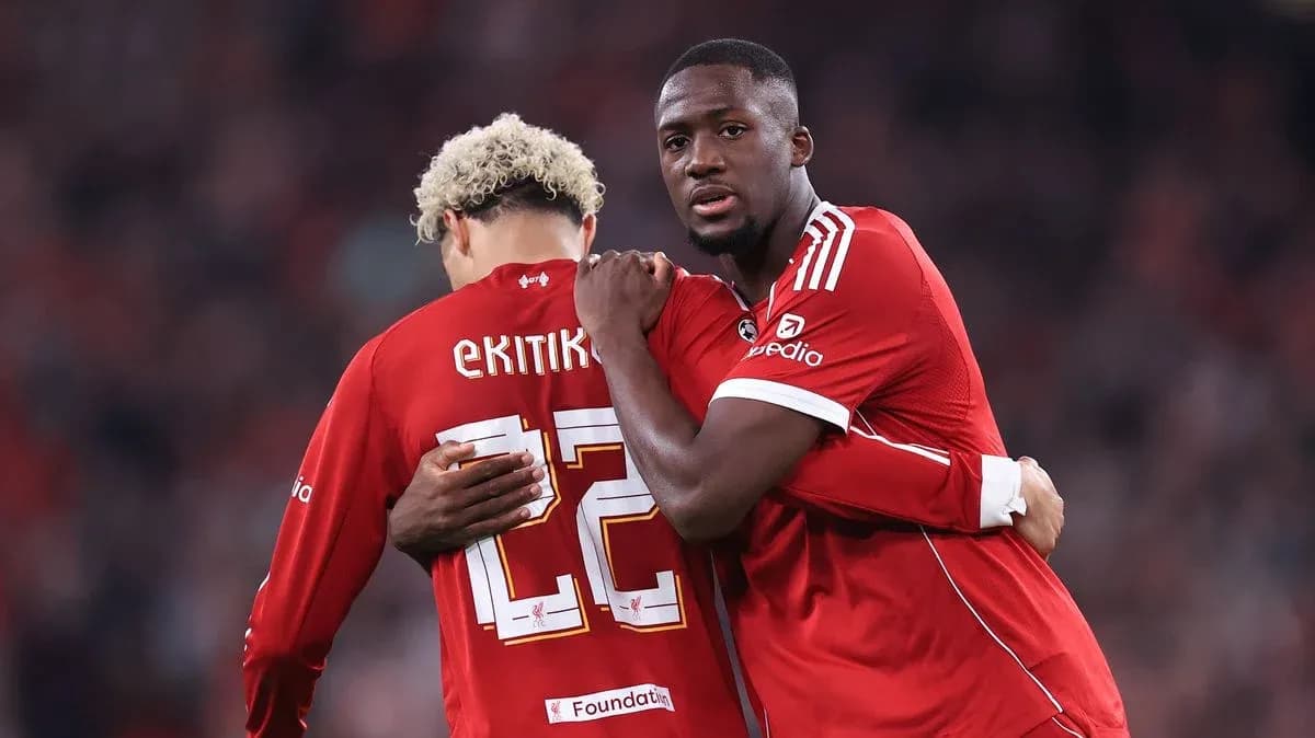 Two players in red jerseys embracing on field Two players in red jerseys embracing on field