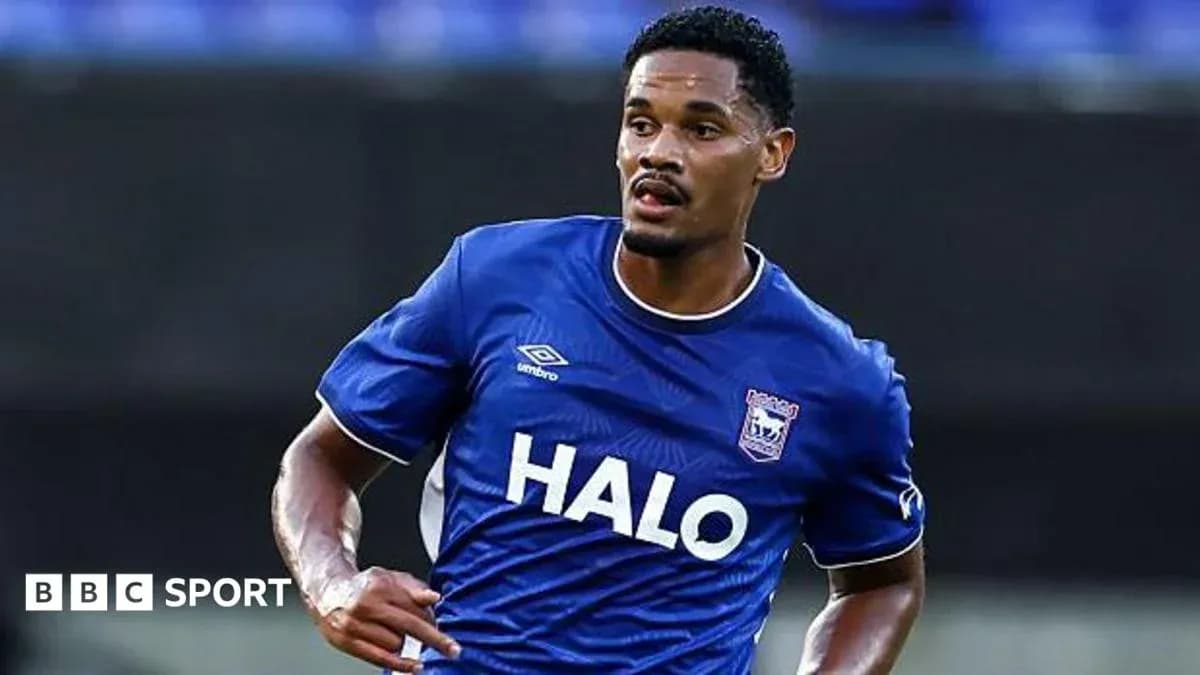 Player in blue jersey running on the pitch Player in blue jersey running on the pitch