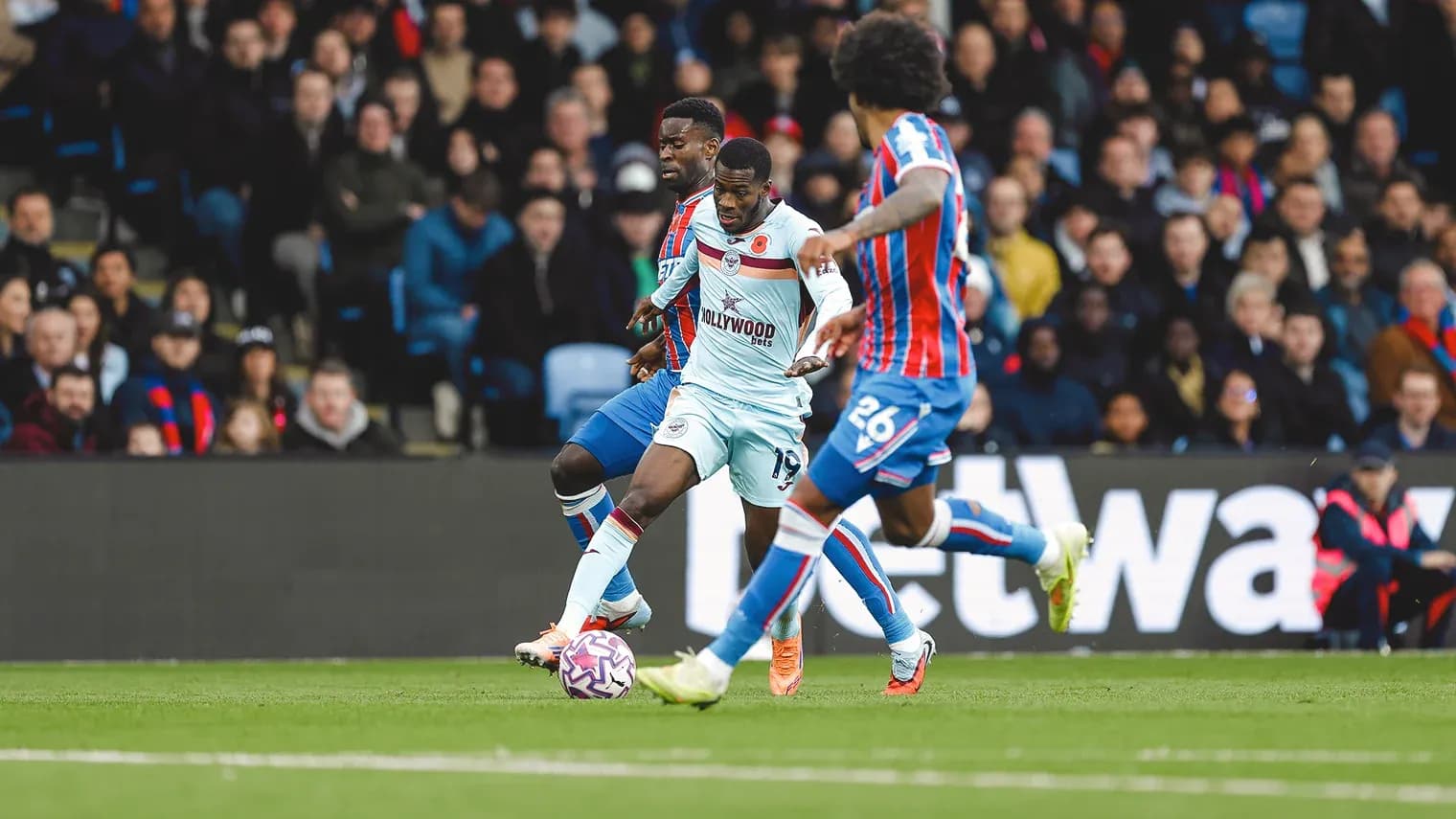 Brentford player dribbling past Crystal Palace defenders Brentford player dribbling past Crystal Palace defenders