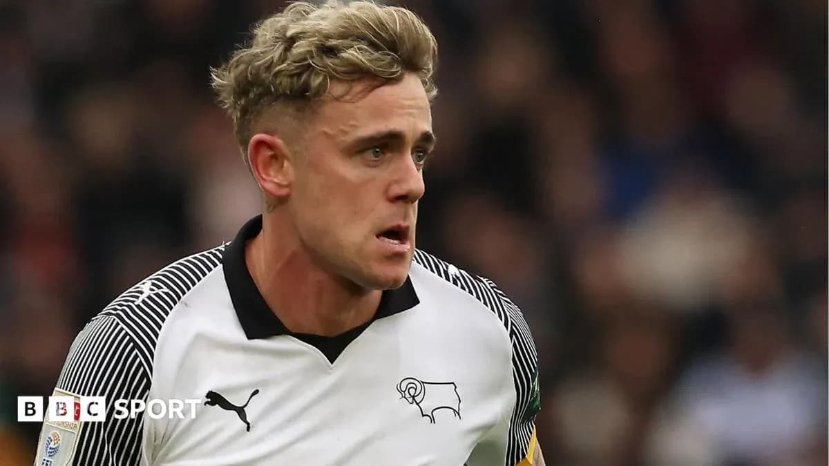 Player in Derby County kit running on the field Player in Derby County kit running on the field