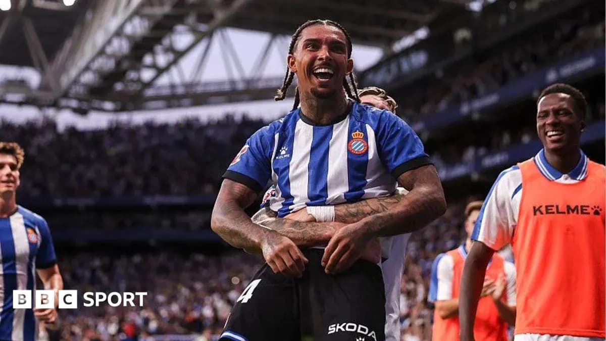 Player celebrating a goal with teammates on field Player celebrating a goal with teammates on field