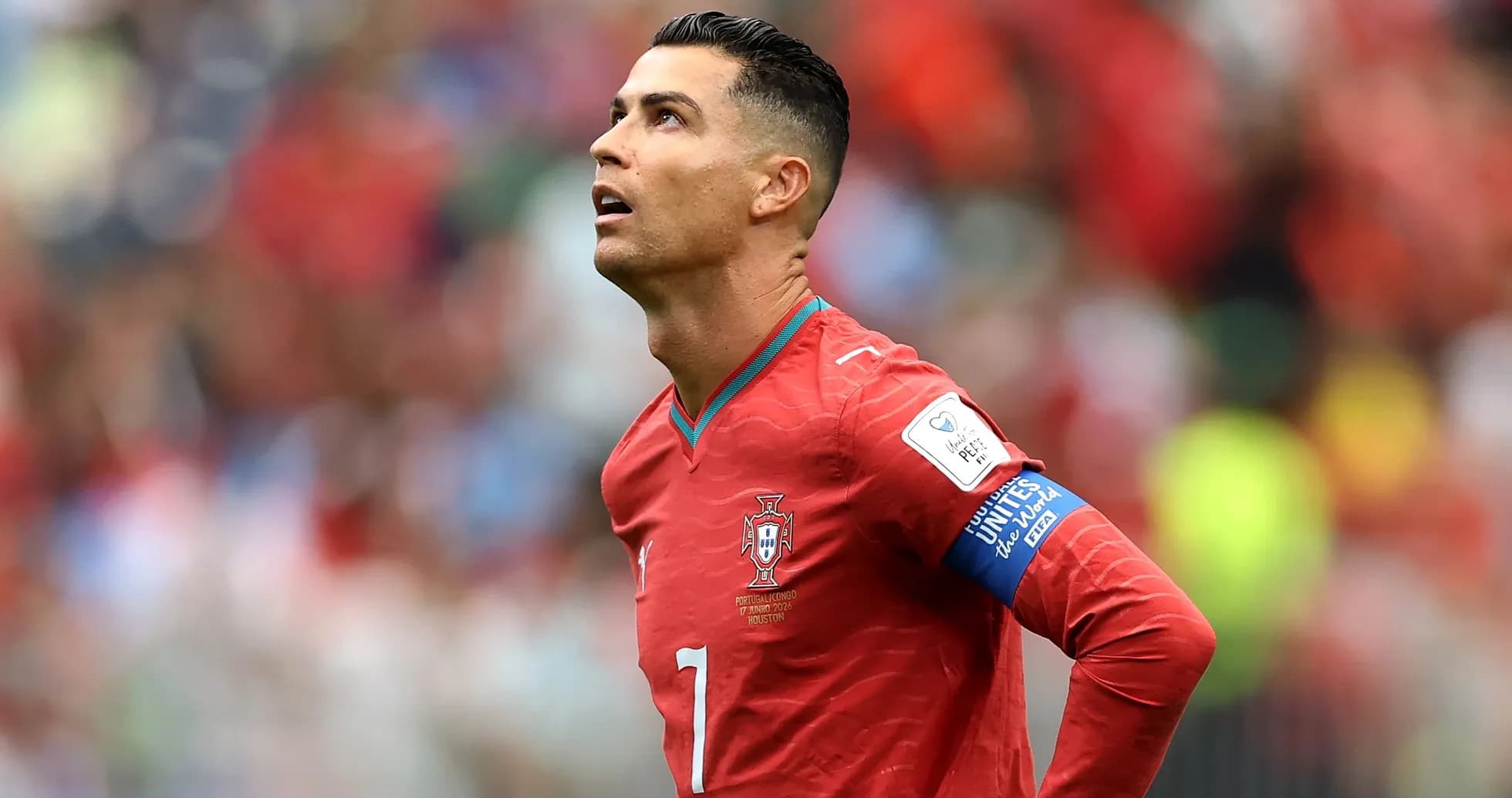 Player in red jersey looking up during match Player in red jersey looking up during match
