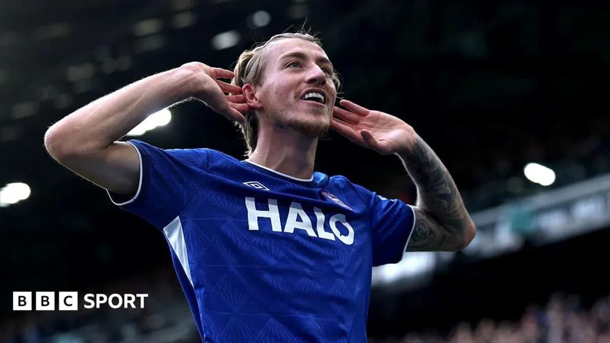 Player celebrating a goal with hands to ears Player celebrating a goal with hands to ears