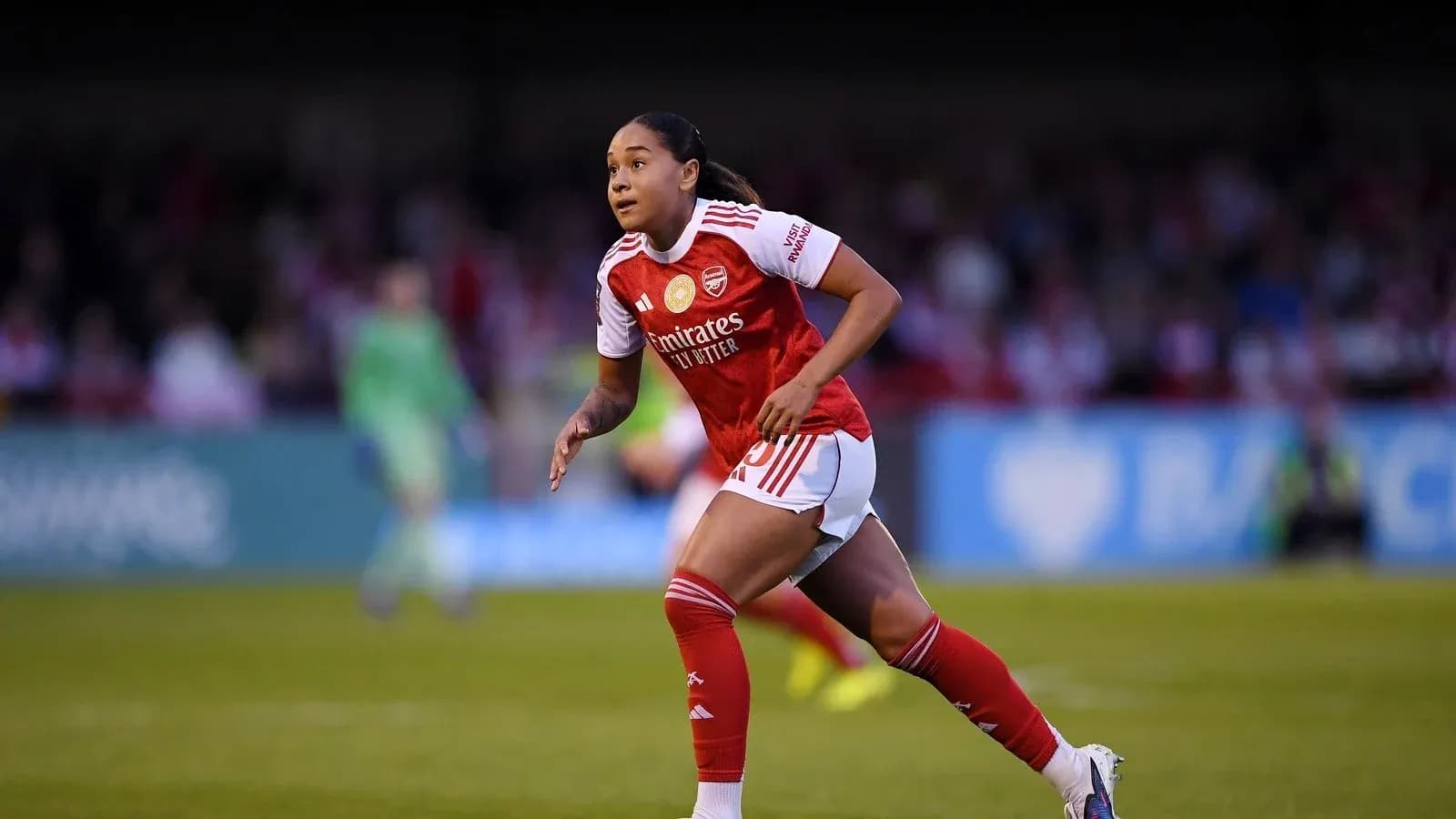 Player running on the field in Arsenal kit Player running on the field in Arsenal kit