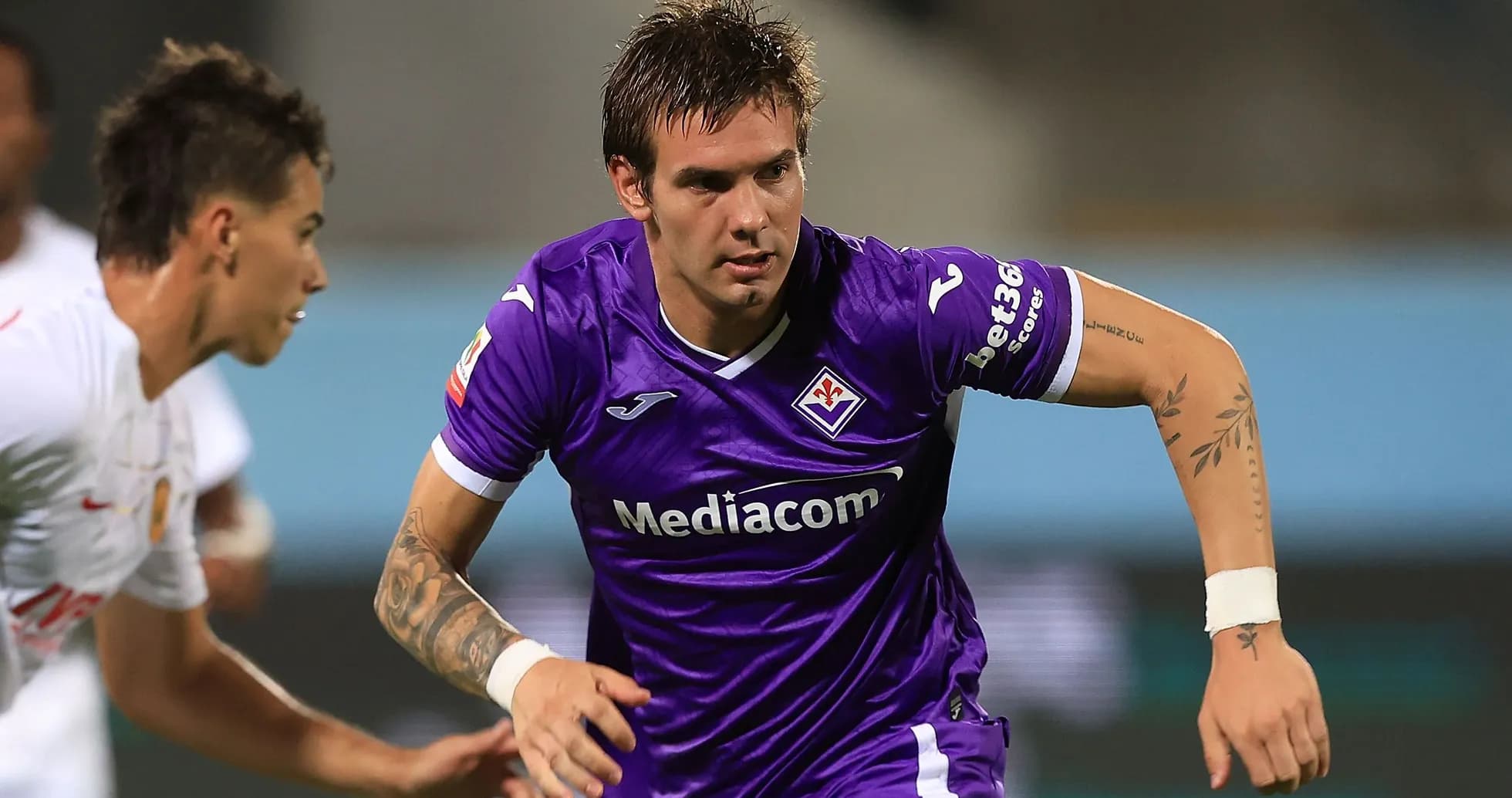 Player in purple jersey sprinting during match Player in purple jersey sprinting during match