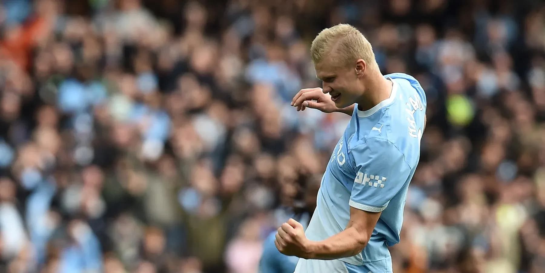 Player celebrating a goal in front of fans Player celebrating a goal in front of fans