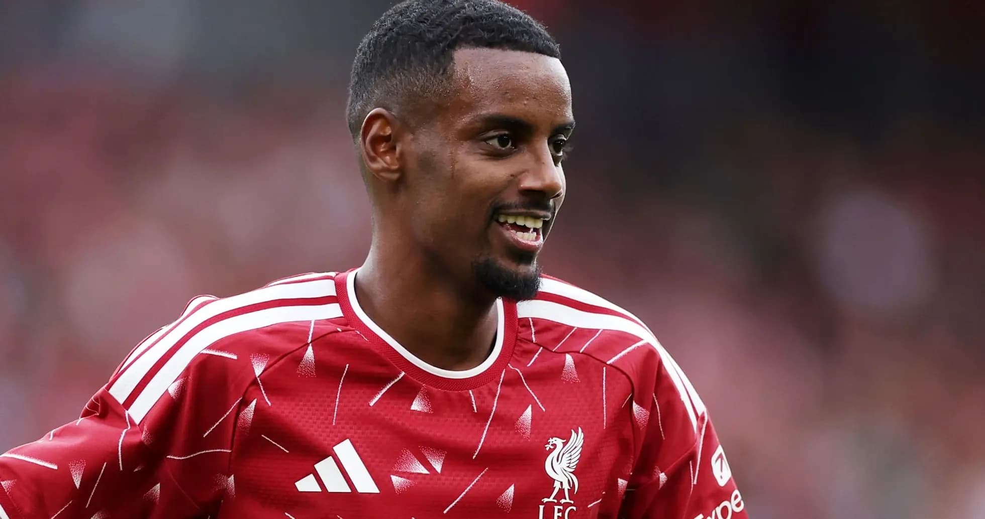 Player smiling in Liverpool FC training kit Player smiling in Liverpool FC training kit