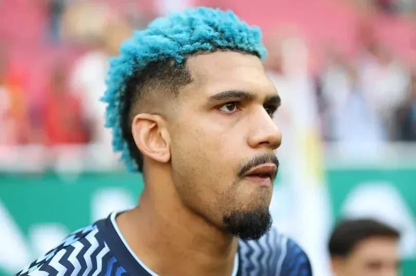 Goalkeeper with blue hair during pre-match warm-up Goalkeeper with blue hair during pre-match warm-up