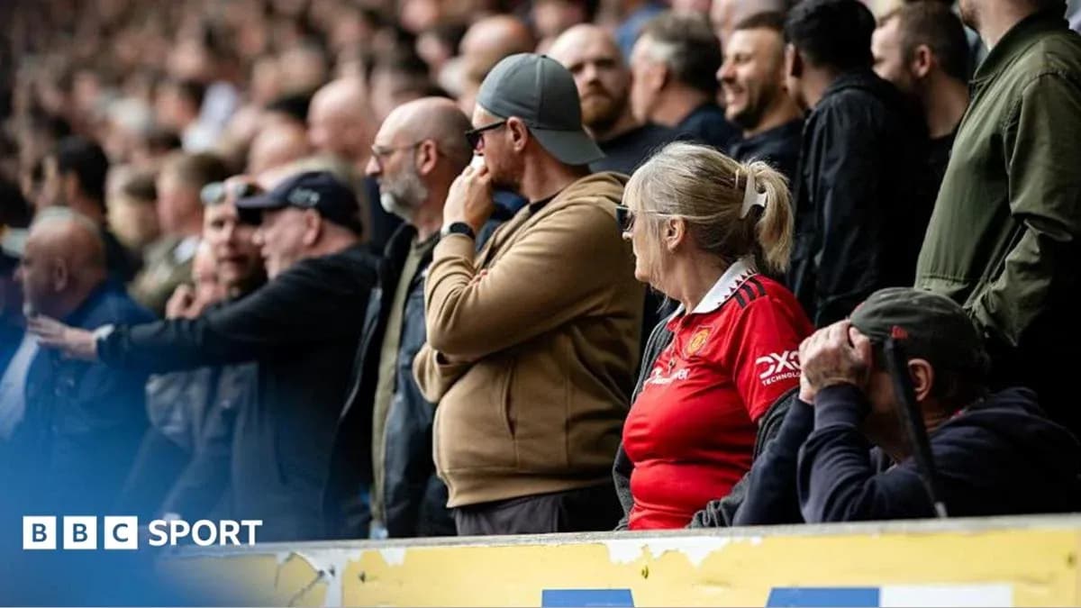 Fans watching a football match in the stands Fans watching a football match in the stands