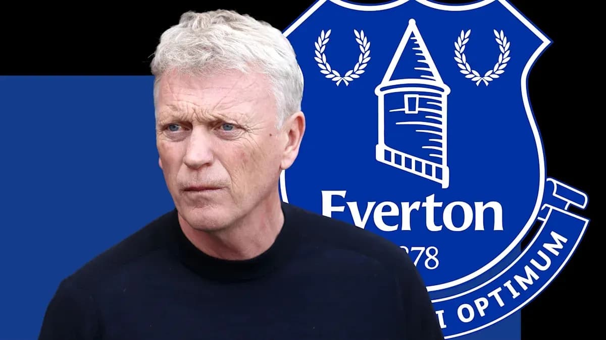Man standing in front of Everton FC logo Man standing in front of Everton FC logo