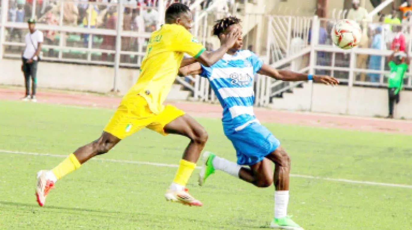 Ikorodu City player tackling Enugu Rangers opponent Ikorodu City player tackling Enugu Rangers opponent