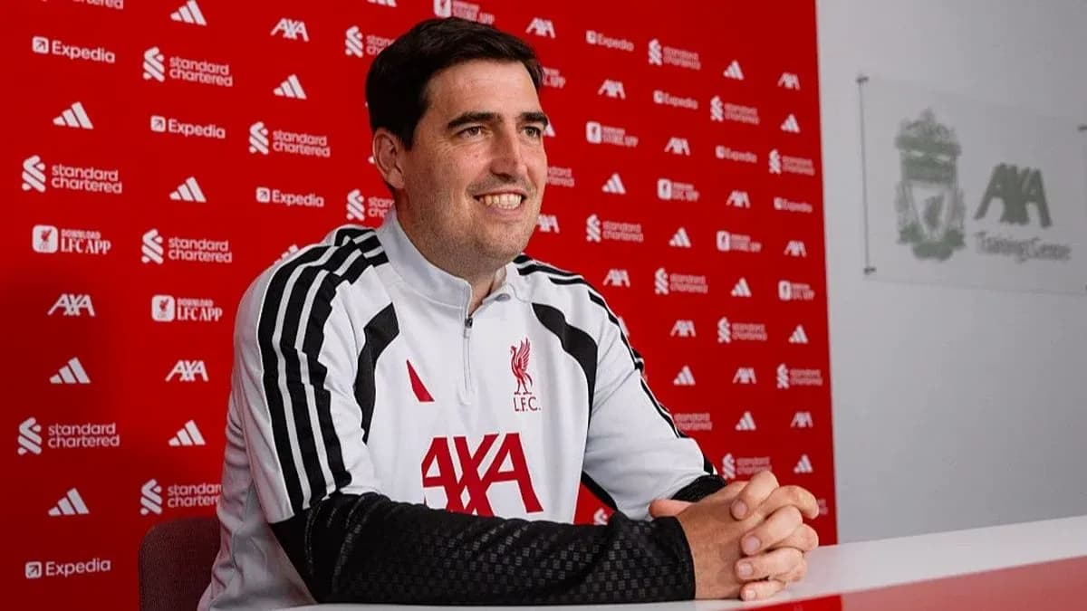 Coach speaking at Liverpool press conference table Coach speaking at Liverpool press conference table