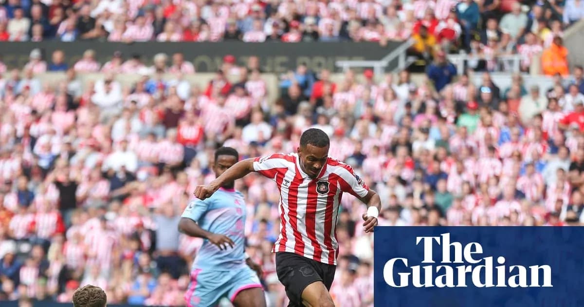Player dribbling past opponent in a crowded stadium Player dribbling past opponent in a crowded stadium