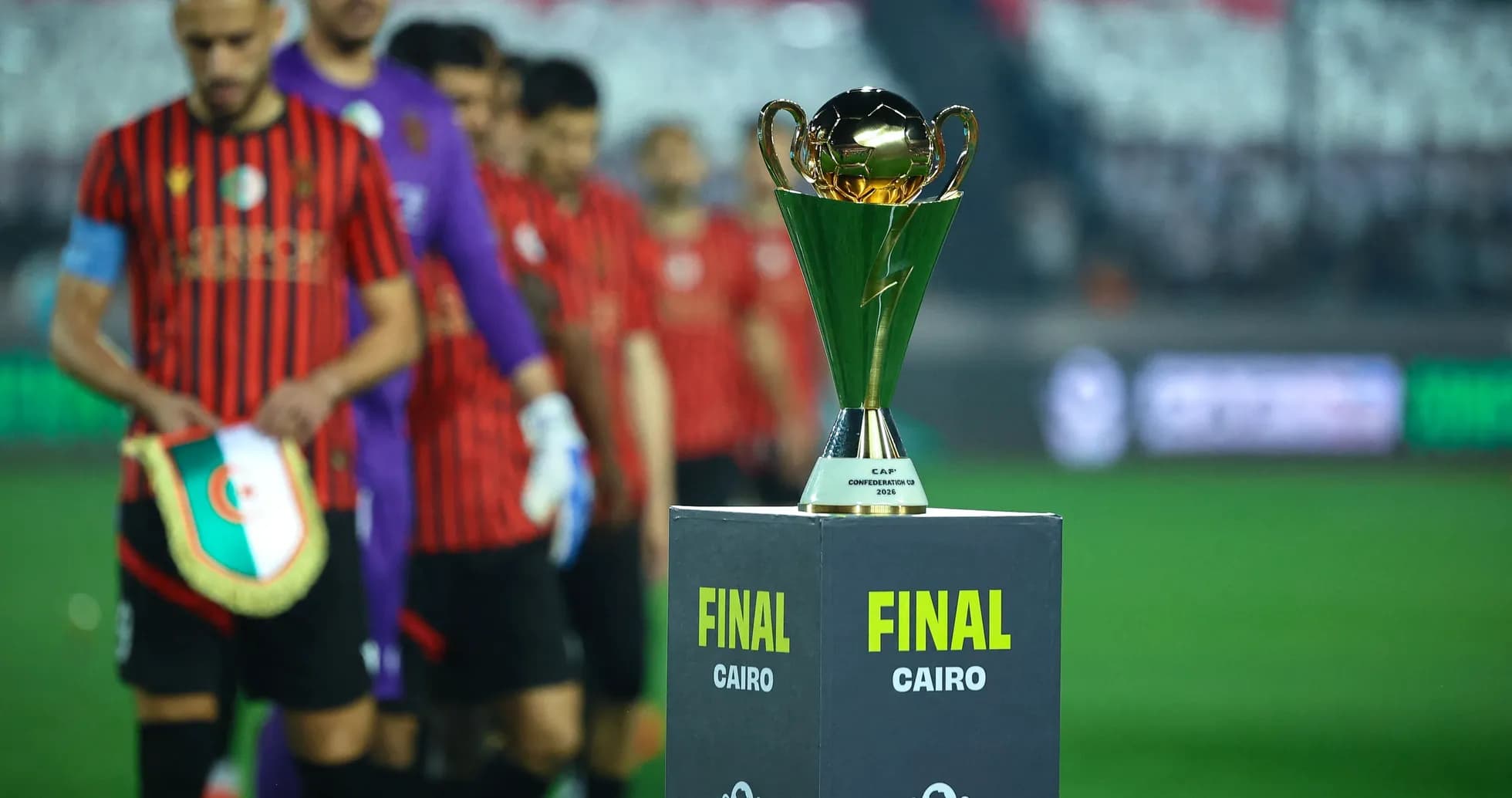 Teams entering field with trophy for final match Teams entering field with trophy for final match