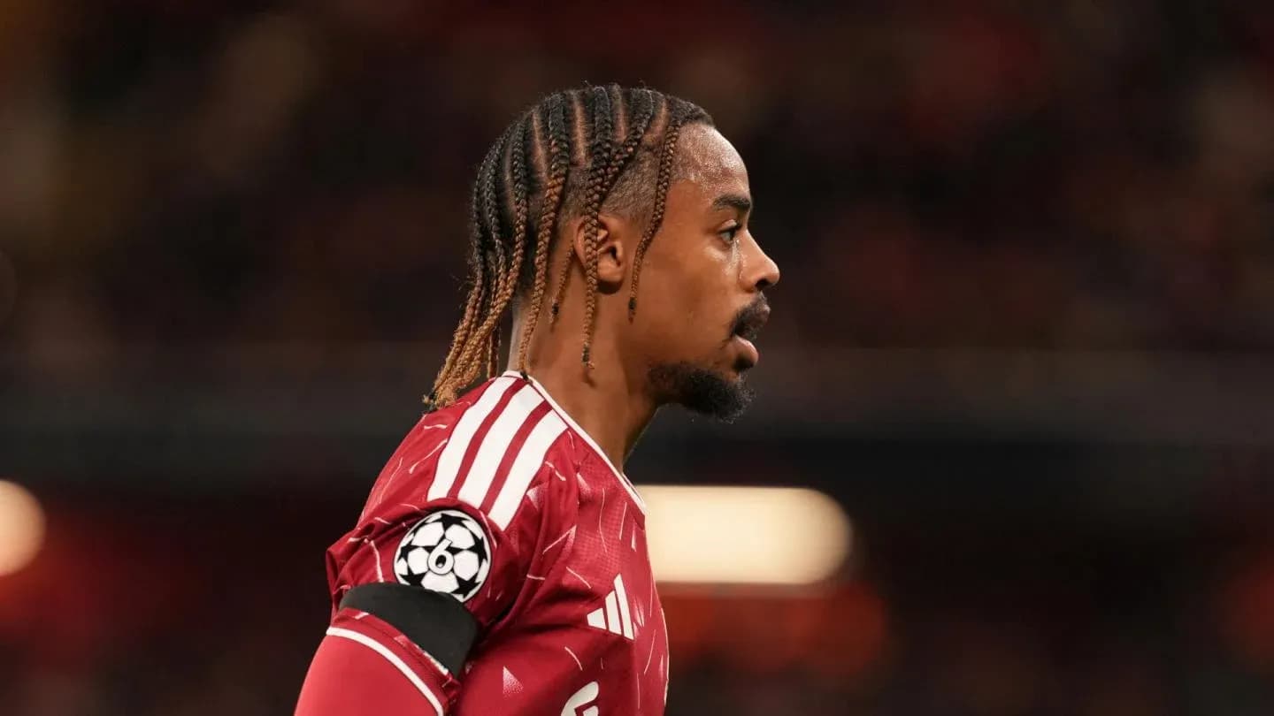 Player in red jersey during match with UEFA badge Player in red jersey during match with UEFA badge
