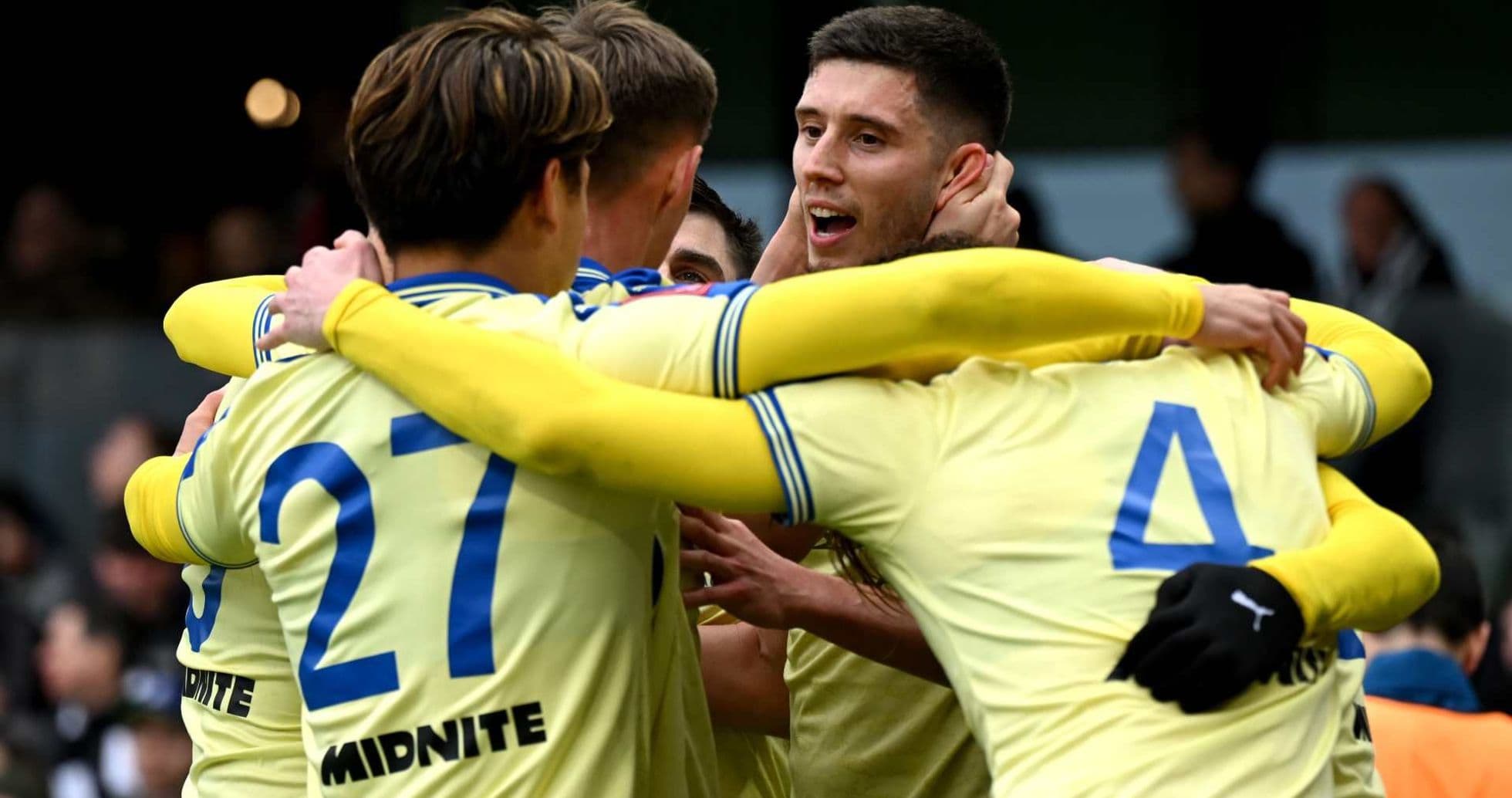 Players celebrating a goal during a match Players celebrating a goal during a match