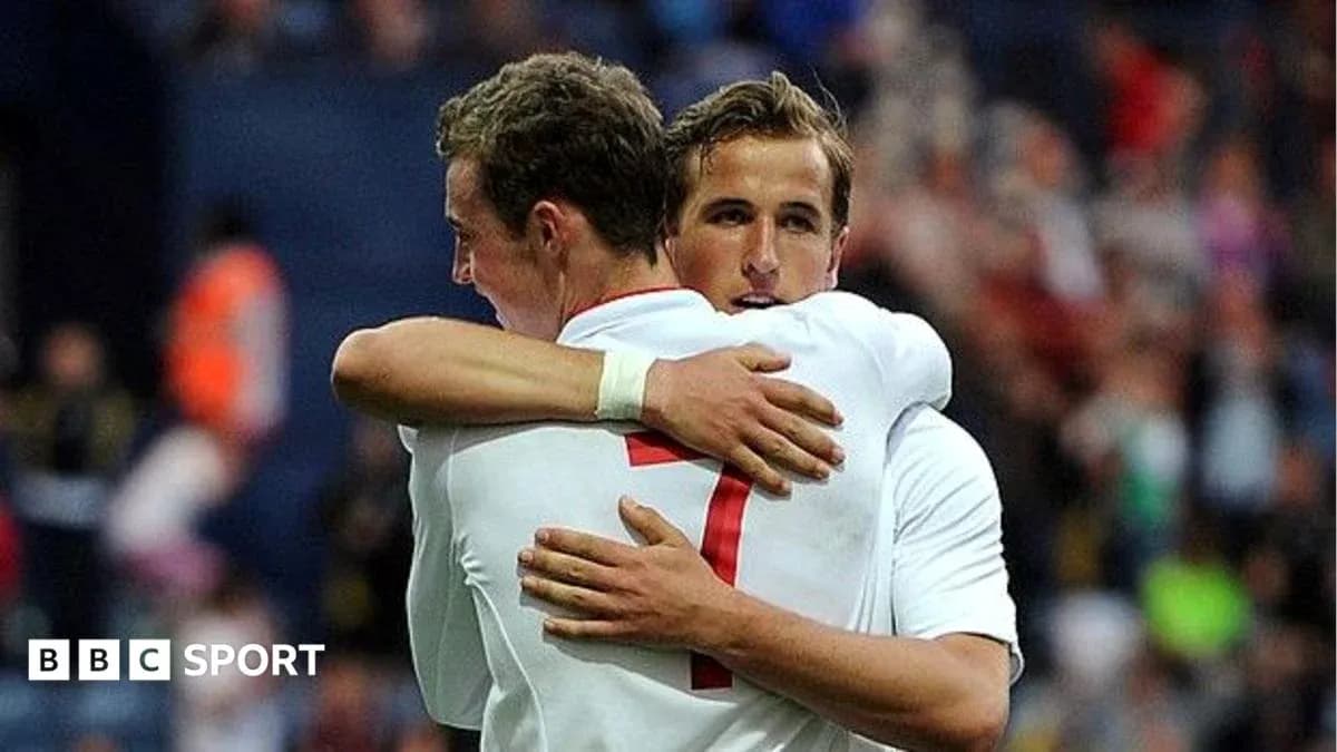 Two players hugging on the field after scoring Two players hugging on the field after scoring