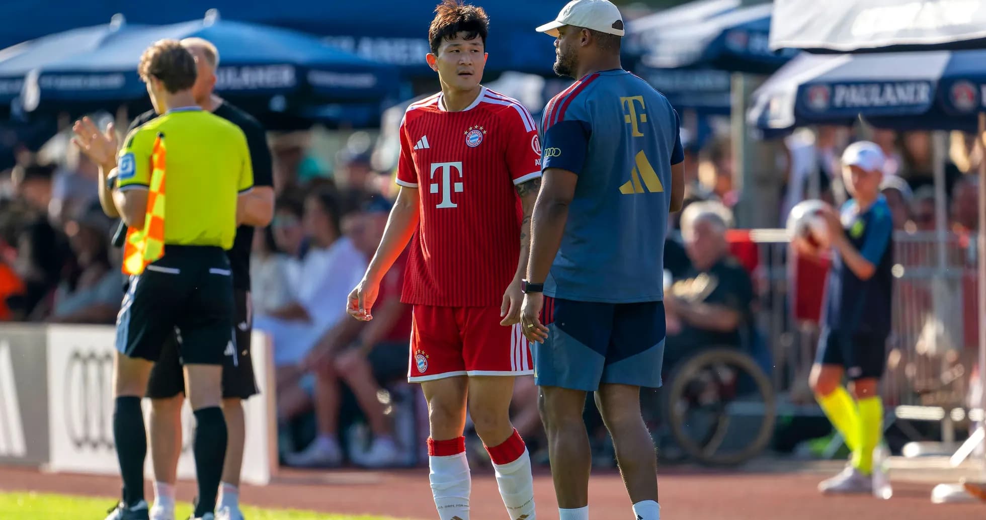 Bayern Munich player talking to coach on sideline Bayern Munich player talking to coach on sideline