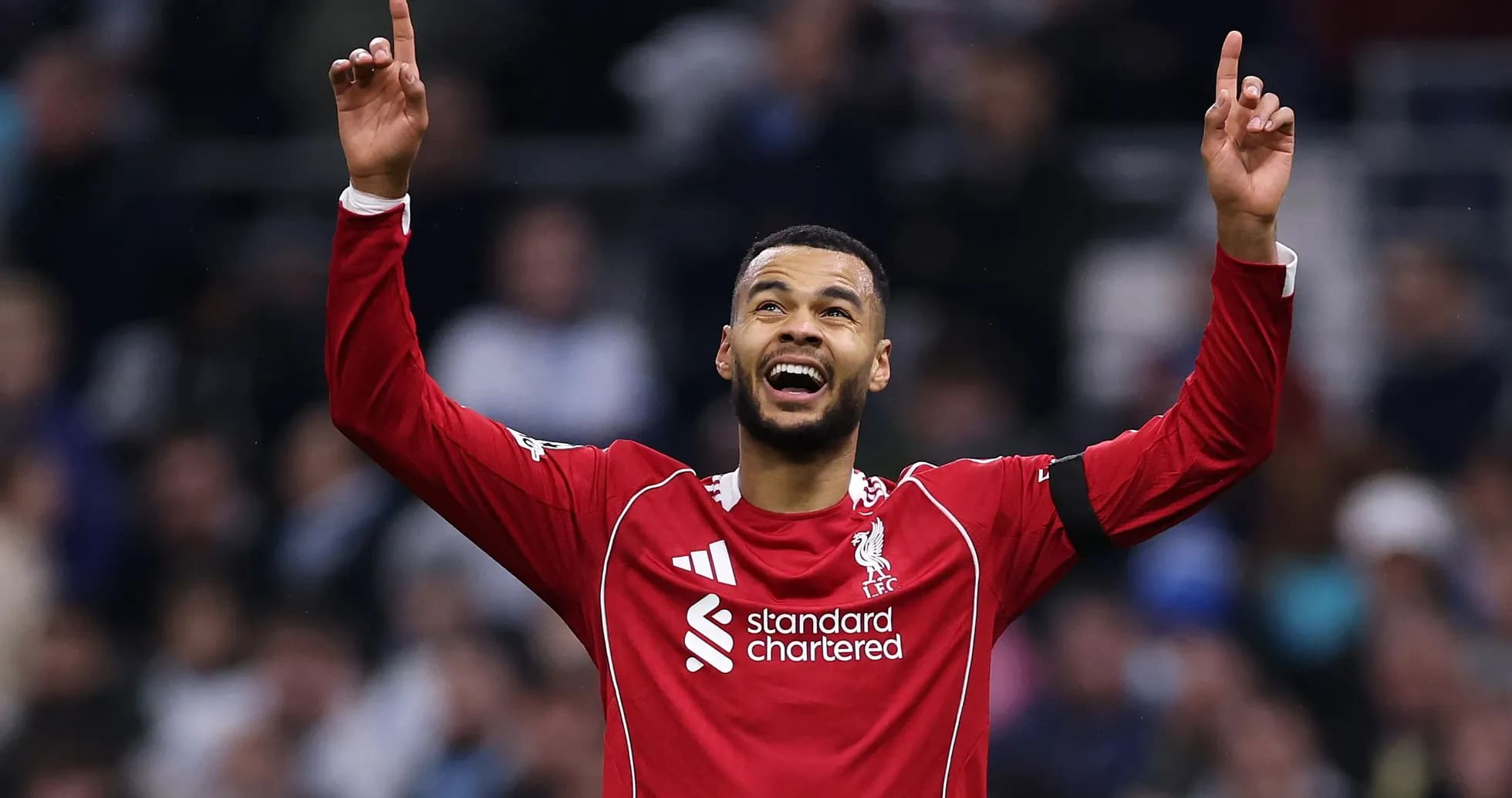 Player celebrating with raised arms in red jersey Player celebrating with raised arms in red jersey