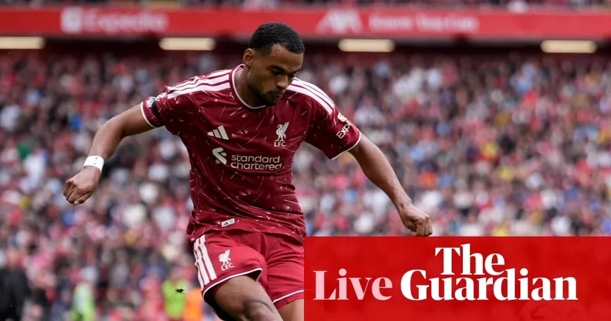 Liverpool player dribbling on the pitch during match Liverpool player dribbling on the pitch during match