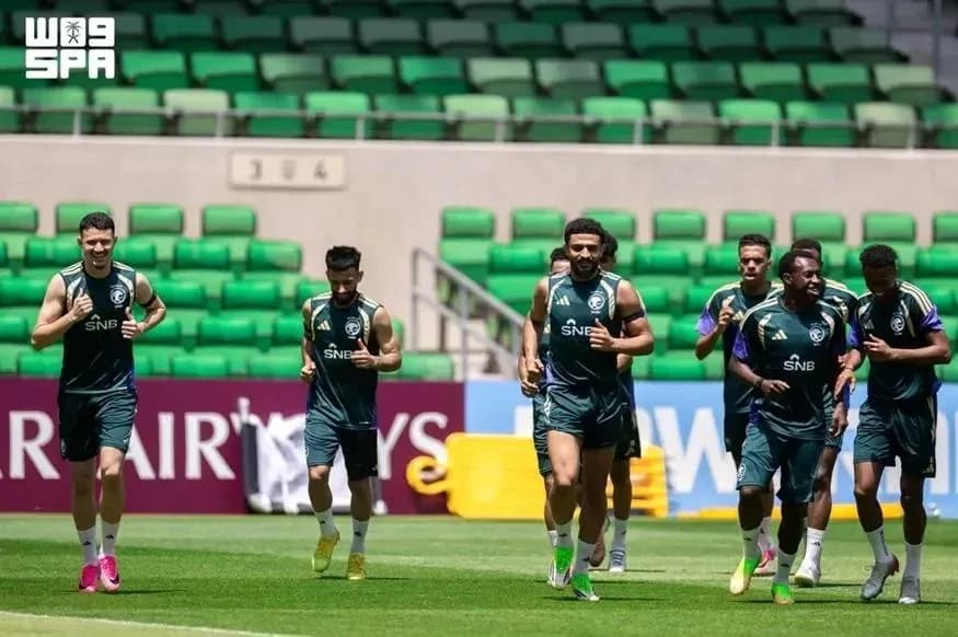 Players jogging during training session on pitch Players jogging during training session on pitch
