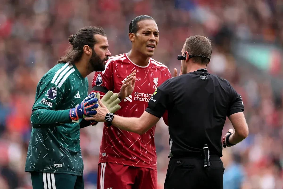 Liverpool players discussing with the referee during match Liverpool players discussing with the referee during match