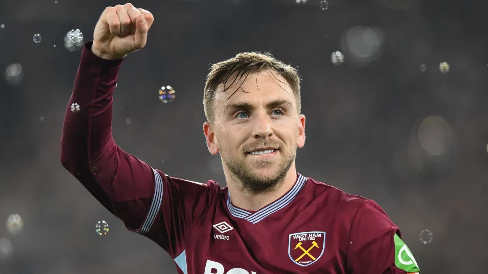 Player celebrating with raised fist and smile Player celebrating with raised fist and smile