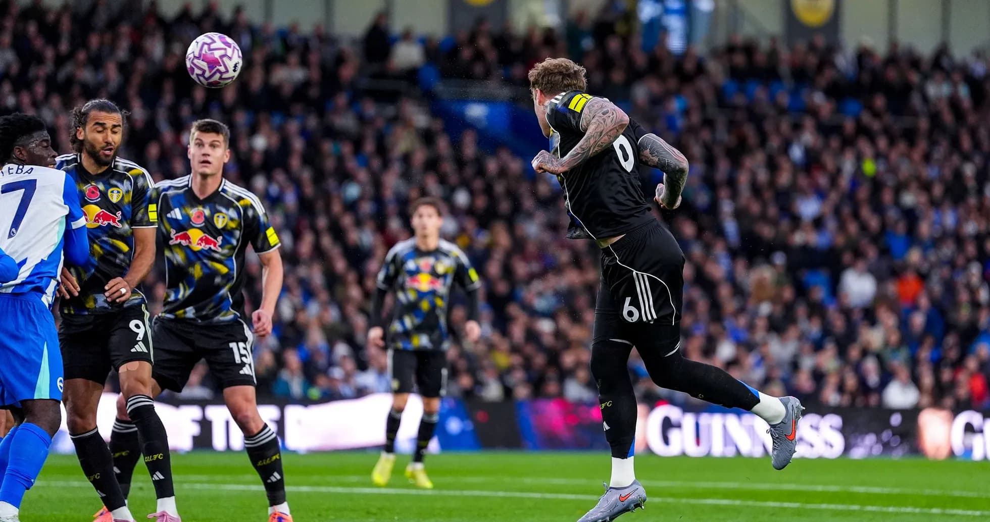 Leeds player heading the ball during match Leeds player heading the ball during match