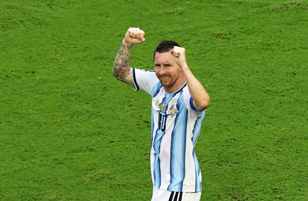 Player celebrating with raised fists on the field Player celebrating with raised fists on the field