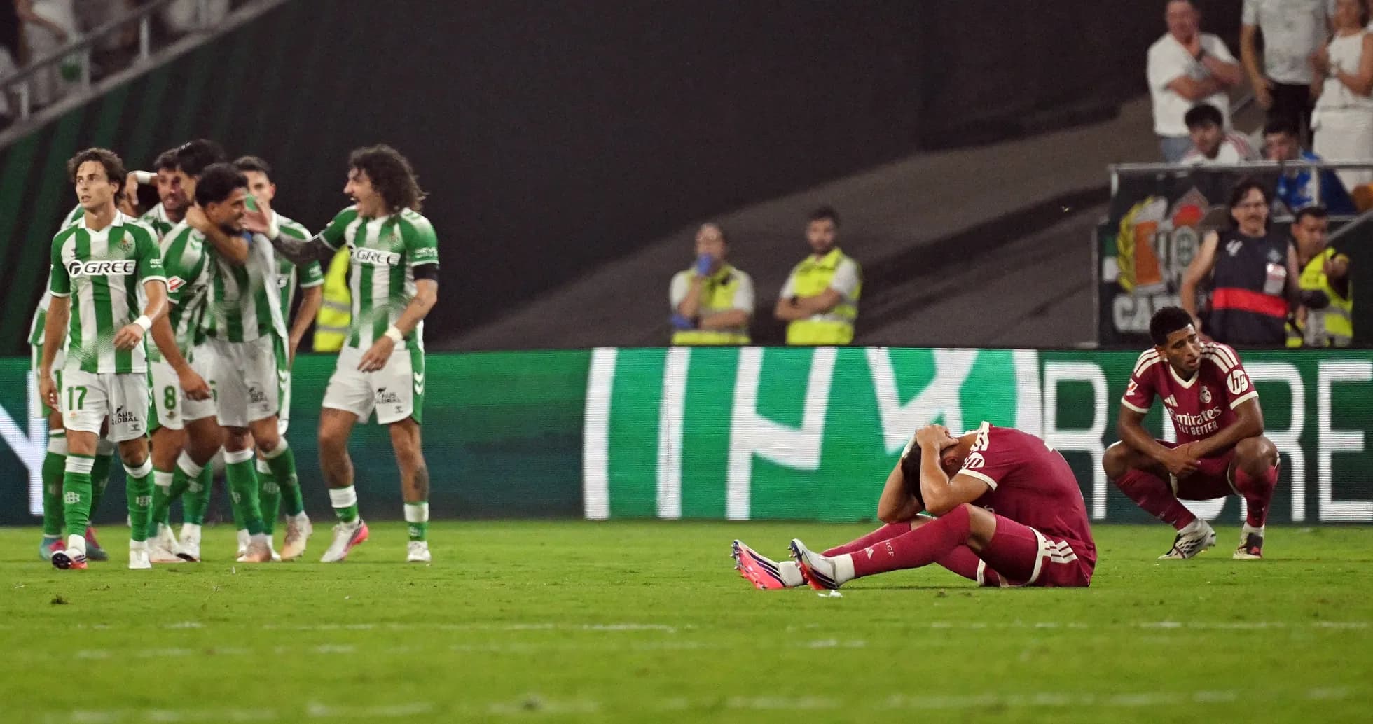 Players reacting after a match, one sitting dejected Players reacting after a match, one sitting dejected