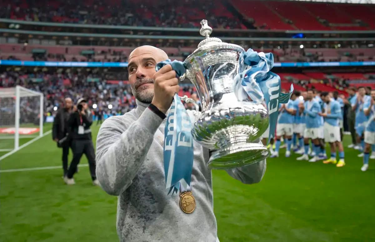 Manager holding trophy at Wembley Stadium celebration Manager holding trophy at Wembley Stadium celebration