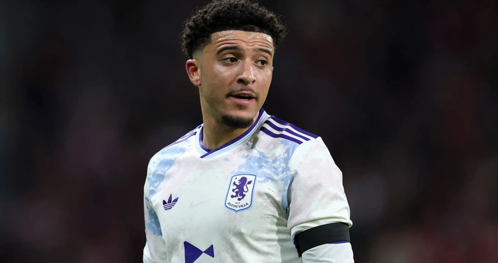 Aston Villa player wearing team jersey on pitch Aston Villa player wearing team jersey on pitch