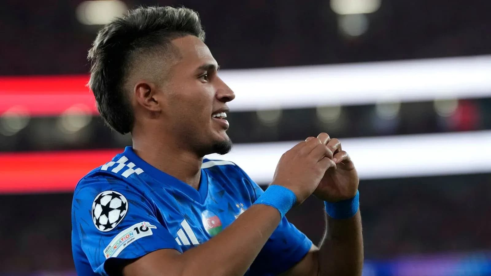 Player celebrating during a Champions League match Player celebrating during a Champions League match