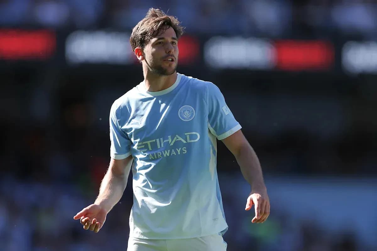 Player in light blue kit walking on the pitch Player in light blue kit walking on the pitch