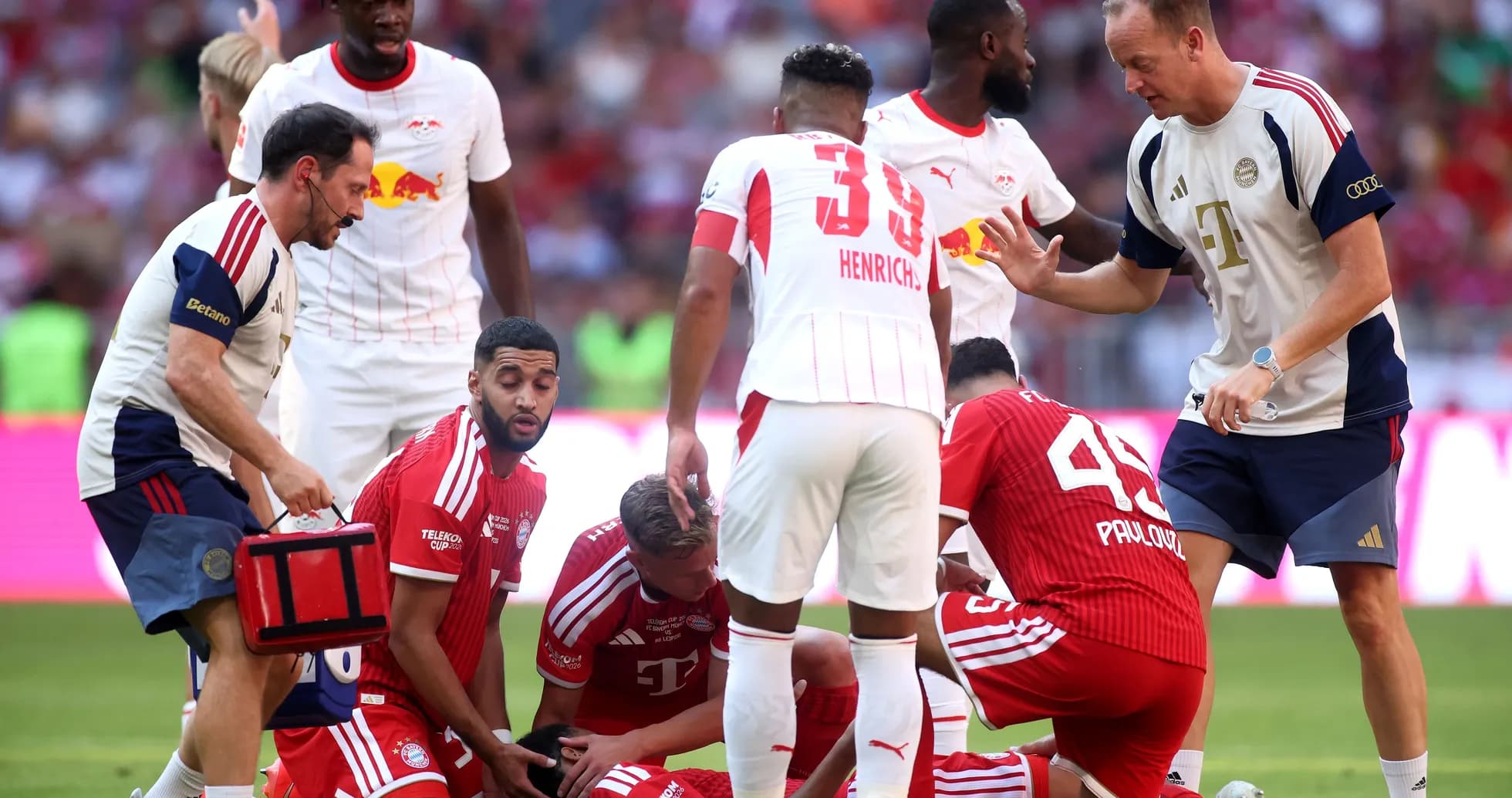 Medical staff attending to injured player on field Medical staff attending to injured player on field