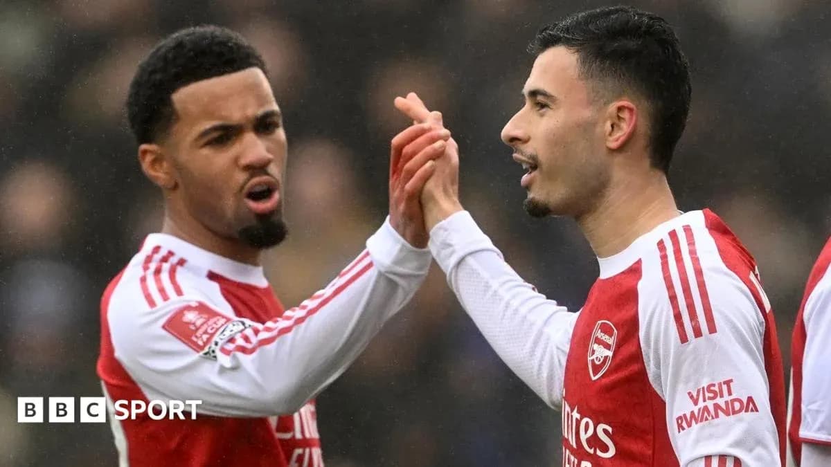 Two Arsenal players celebrating a goal together Two Arsenal players celebrating a goal together