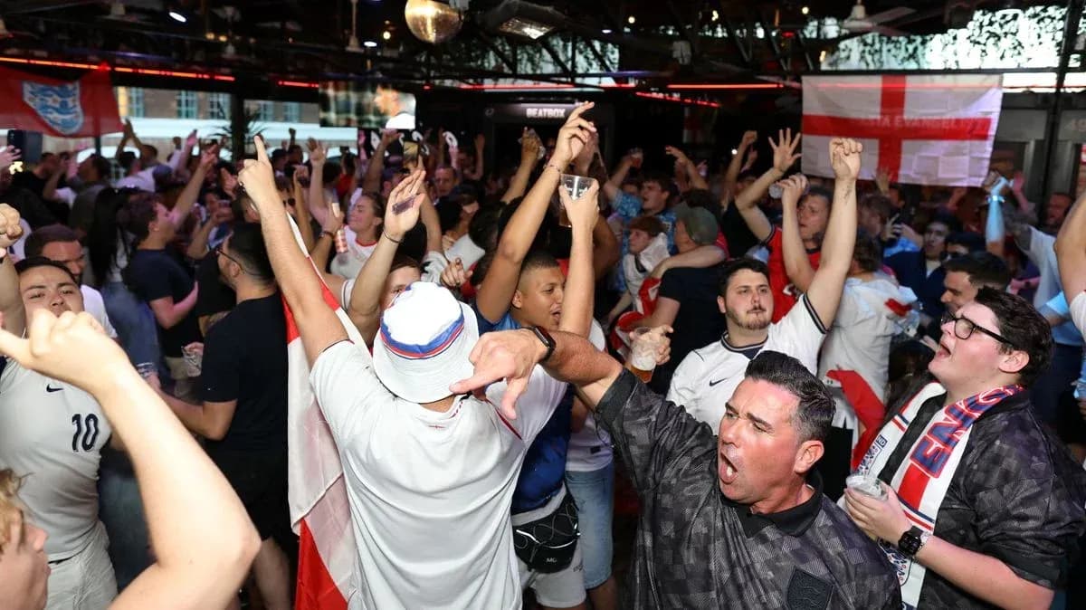 Crowd of fans celebrating in a sports bar Crowd of fans celebrating in a sports bar