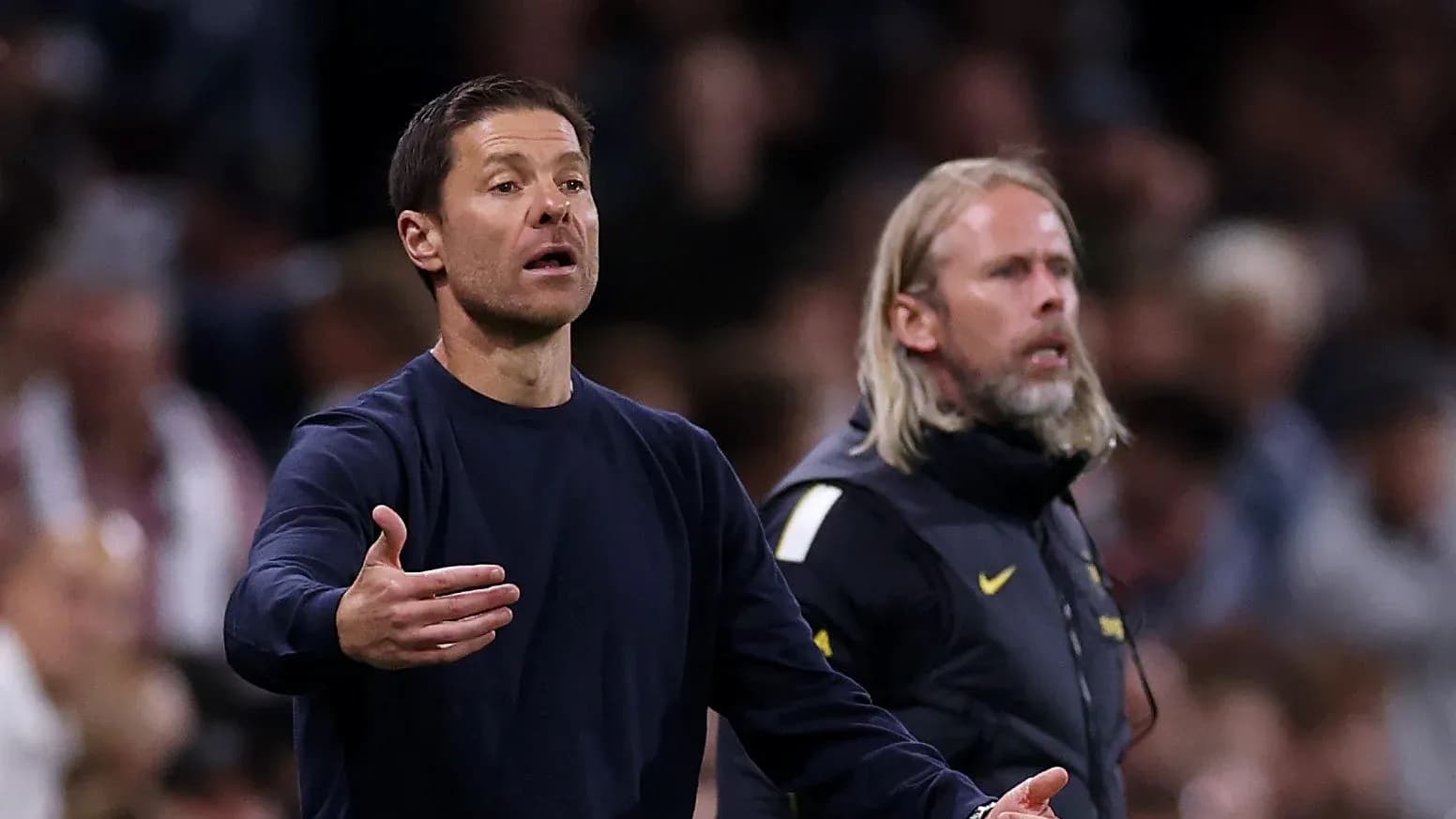 Coaches gesturing during a match on the sidelines Coaches gesturing during a match on the sidelines
