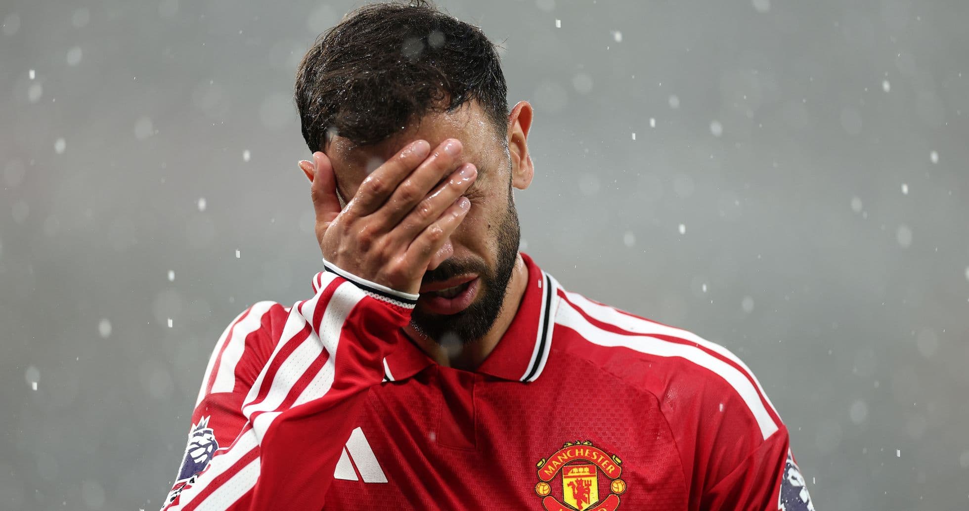 Player covering face during match in rain Player covering face during match in rain