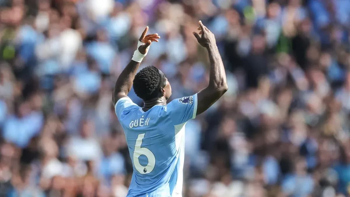 Player celebrating with arms raised during match Player celebrating with arms raised during match