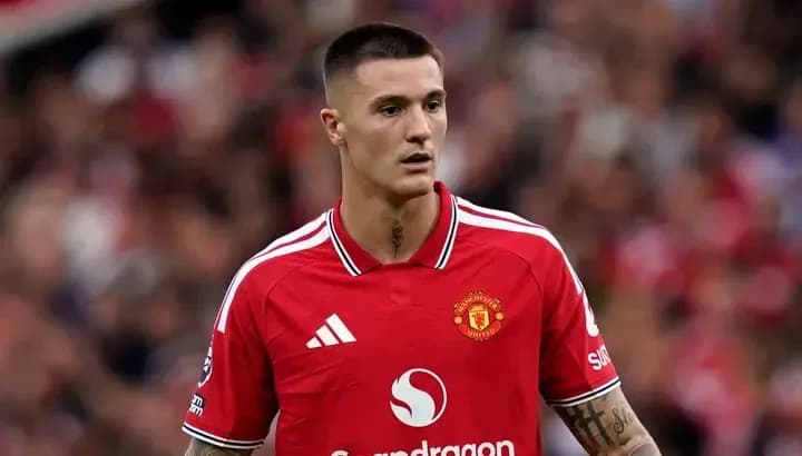 Player in Manchester United jersey on the pitch Player in Manchester United jersey on the pitch