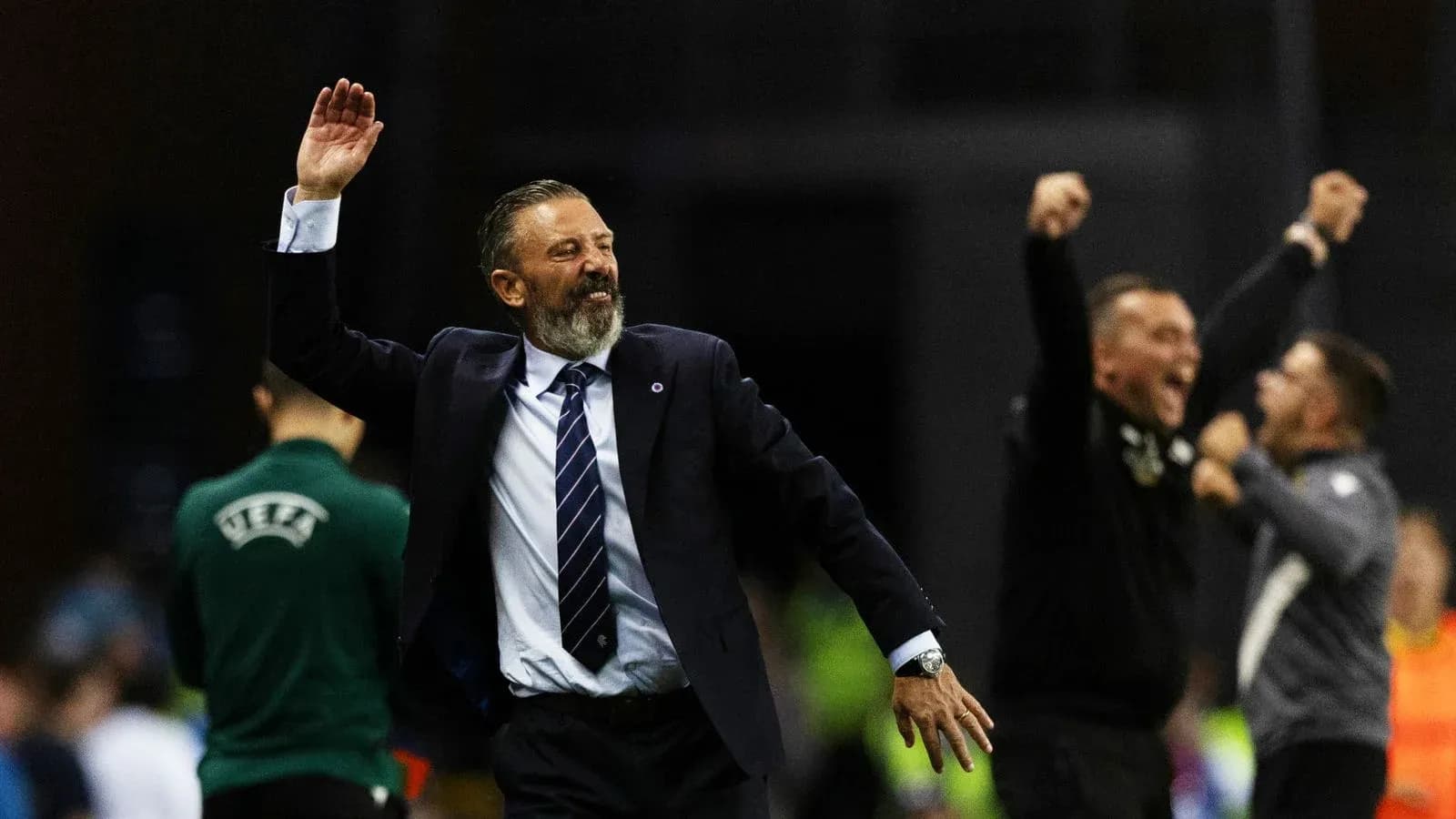 Coach celebrating with staff after match victory Coach celebrating with staff after match victory