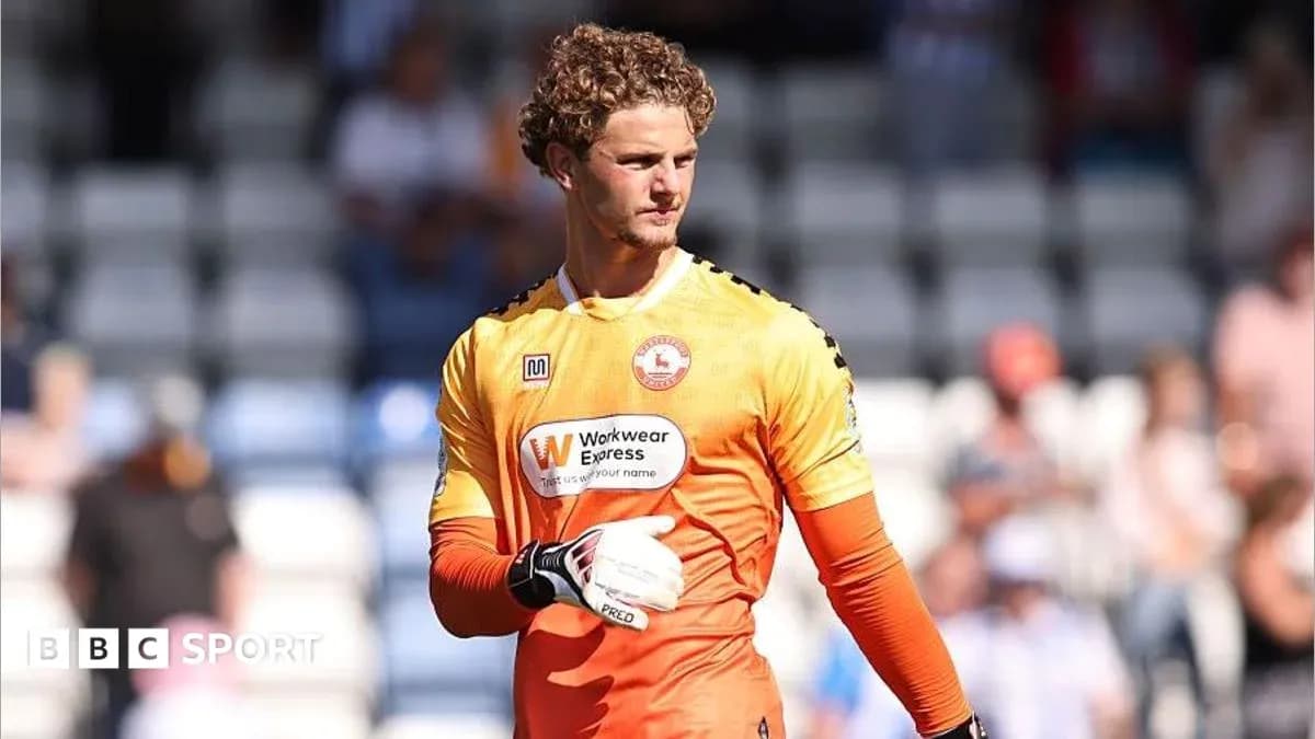 Goalkeeper in orange kit preparing for match Goalkeeper in orange kit preparing for match